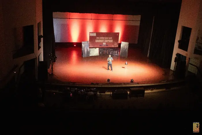 Wide view of the lit stage during the comedy night