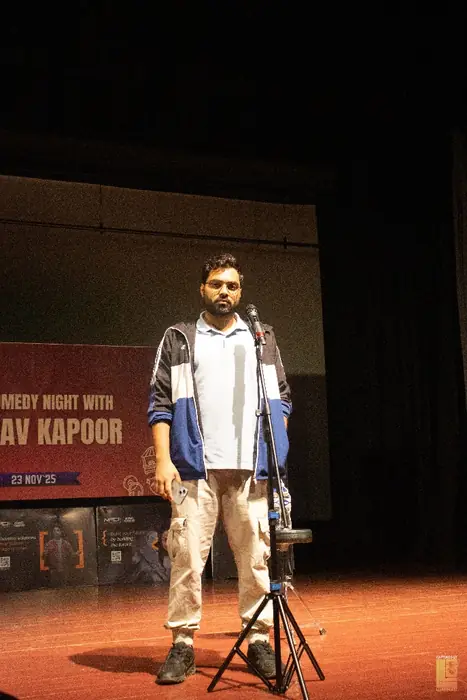 The host at the microphone before the comedy night begins