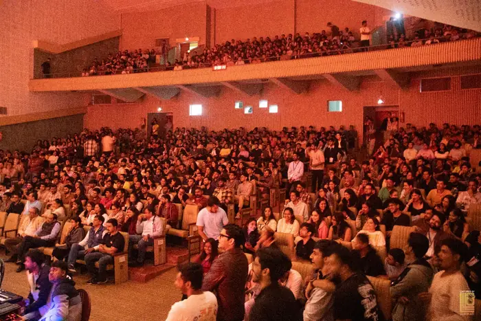 Audience filling the auditorium stalls and balcony at the comedy night