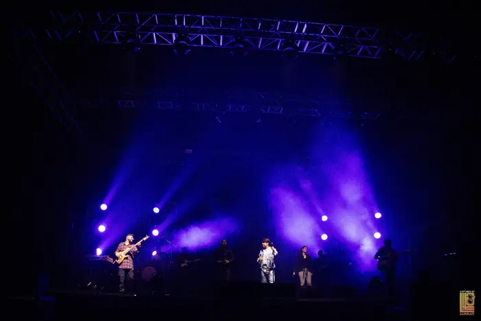 Ankit Tiwari and his band on stage under blue and purple lights