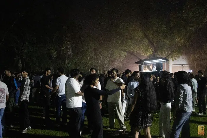 Crowd dancing on the lawn in front of the DJ booth