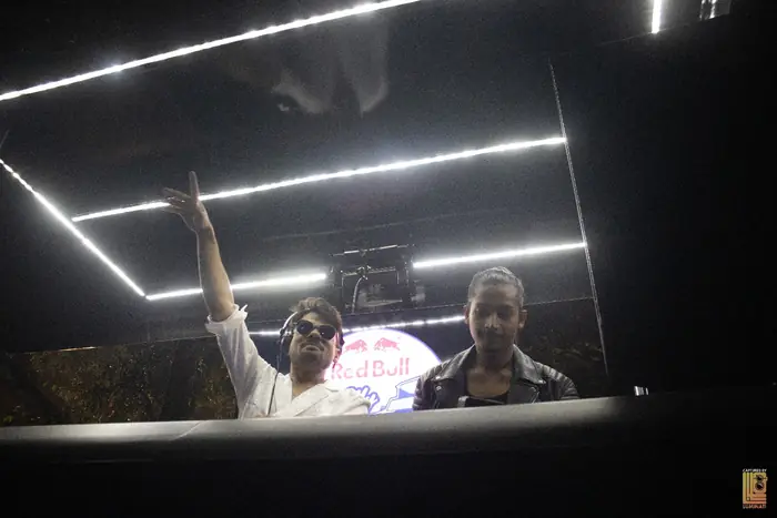 DJ raising a hand in the booth during the night set