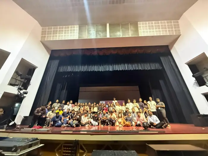 The festival team gathered for a group photo on the auditorium stage